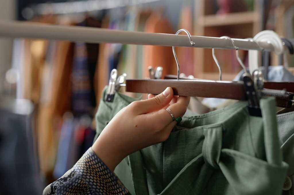 Hand of Woman Taking Hanger with Clothes